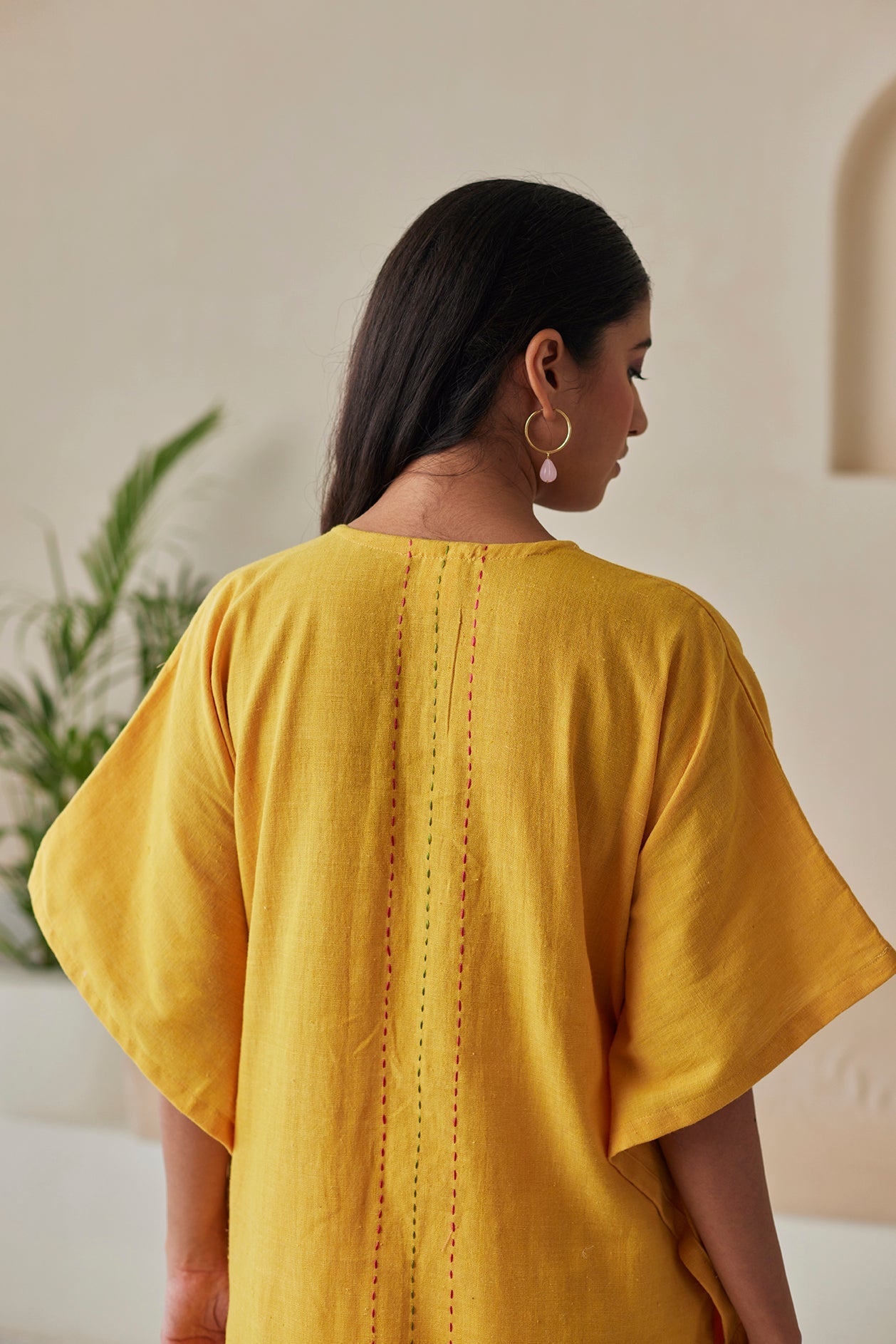 Phulkari hand-embroidered mustard kaftan with white khaddar pants