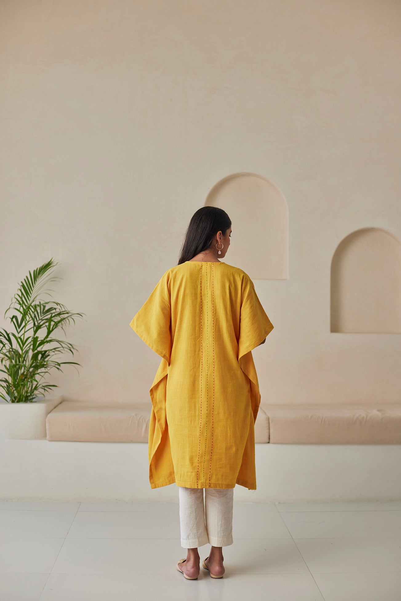 Phulkari hand-embroidered mustard kaftan with white khaddar pants